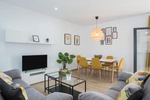 a living room with a couch and a table at Villa Sandra solo familias in Cádiz