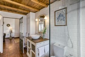 a bathroom with a toilet and a sink at Ca la Yaya in Llança +23 photos
