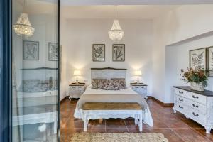 a bedroom with a bed and two dressers and two lamps at Ca la Yaya in Llança
