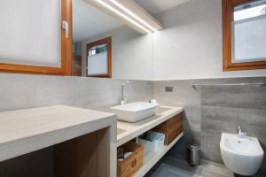 a bathroom with a sink and a toilet at Casa Nadia in Verceia +17 photos
