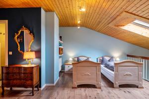 a bedroom with two beds and a mirror in a room at Himmelblau in Schönwald +35 photos