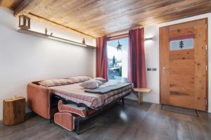 a bedroom with a bed and a wooden ceiling at Casa Nadia in Verceia