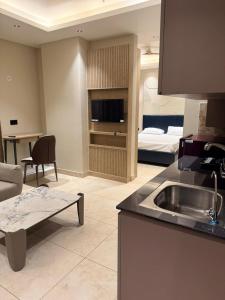 a kitchen and living room with a couch and a bed at Town Centers in Ghaziabad