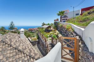 a staircase leading up to a house with the ocean in the background at Volcán 18 in Tanque