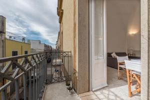 a room with a balcony with a view of a city at Dimora Cece in Francavilla Fontana