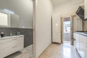 a kitchen with white cabinets and a counter top at Dimora Cece in Francavilla Fontana +13 photos