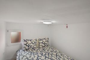 a bedroom with a bed with a white wall at Loft Noemi - La Aldea in San Nicolás