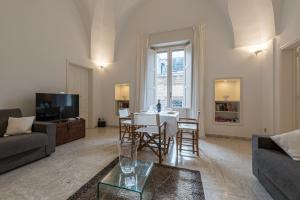 a living room with a table and chairs in it at Dimora Cece in Francavilla Fontana