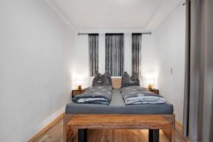 a bed in a room with two pillows on it at Casa Doro in Donaueschingen