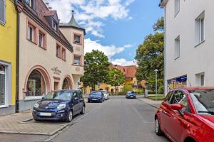 a row of cars parked on a city street at Casa Doro in Donaueschingen