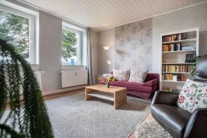 a living room with a purple couch and a coffee table at Landglück in Hohenmocker