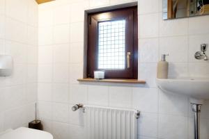 a bathroom with a toilet and a sink and a window at die Bahnstation in Friedrichshafen +26 photos