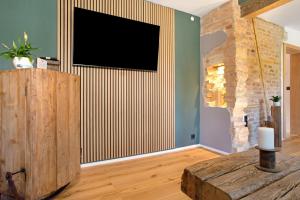 a living room with a flat screen tv on a wall at die Bahnstation in Friedrichshafen