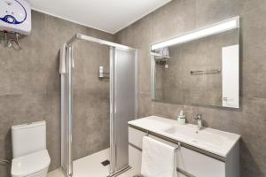 a bathroom with a sink and a shower and a toilet at Ocean wave retreat in Patalavaca +13 photos