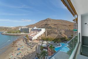 a view of the beach from a balcony of a resort at Ocean wave retreat in Patalavaca