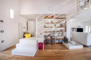 a white staircase in a living room with wooden floors at Villa Iagra in Tiarno di Sopra