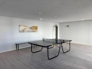 a black table in a white room with a bench at Apartment Dargies in Cuxhaven +18 photos