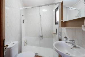 a bathroom with a shower and a toilet and a sink at Casa Zaida Olivos in San Sebastián de la Gomera +18 photos