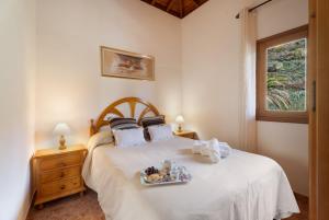 a bedroom with a bed with a tray of food on it at Casa Zaida Olivos in San Sebastián de la Gomera