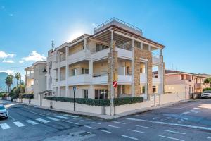 a white building on the side of a street at Cormorani - Appartamento 13 in Golfo Aranci