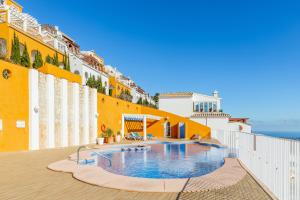 a swimming pool on the side of a building at 180-degrees sea view with pool in Benitachell