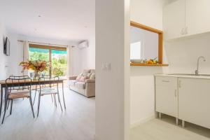 a kitchen and living room with a table and chairs at Casa Yolima in Sóller +13 photos