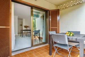a dining room with a table and chairs and a patio at Casa Yolima in Sóller