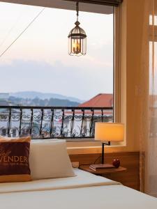 a bedroom with a bed and a large window at Sweet Lavender Hotel - Ngay chợ đêm Đà Lạt in Da Lat