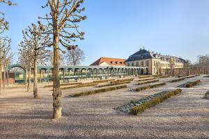 a park with trees in front of a building at Dachgeschosswohnung Wohllebe in Hannover