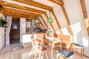 a kitchen and dining room with a table and chairs at Ferienhaus Moritz in Siegsdorf +12 photos