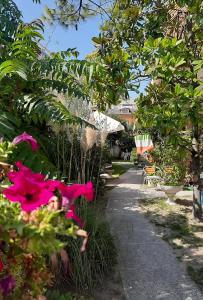 a garden with pink flowers and a pathway at Euroholiday Village 1G in Lido di Jesolo