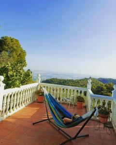 a woman laying in a hammock on a balcony at Sombrero Cordobé in Córdoba