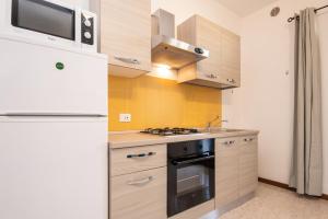 a kitchen with a refrigerator and a stove top oven at Il grappolo monolocale in Sirmione +15 photos