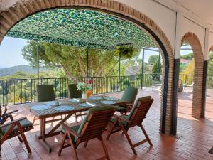 a patio with a table and chairs on a deck at Sombrero Cordobé in Córdoba