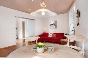 a living room with a red couch and a table at Ferienwohnung Dietsche Todtnau in Todtnau