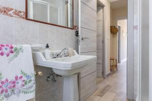 a white bathroom with a sink and a mirror at Brizna in Oreña +25 photos