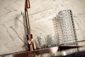 a pair of glasses sitting on a glass table at Schenna Chalet - Apt Dora in Schenna +23 photos