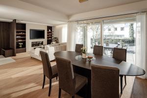 a dining room and living room with a table and chairs at Schenna Chalet - Apt Dora in Schenna