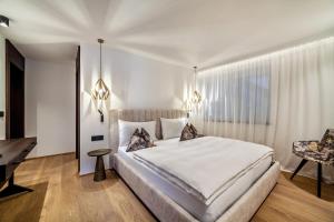 a bedroom with a large bed and a desk at Schenna Chalet - Apt Dora in Schenna