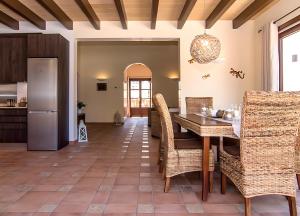 a kitchen and dining room with a table and chairs at Pescadores in Cala Ratjada +10 photos