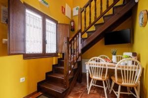a yellow room with a table and chairs and a staircase at Apto Amarillo - Casa el gaitero in Susacasa