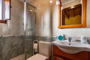 a bathroom with a toilet and a sink and a shower at Apto Amarillo - Casa el gaitero in Susacasa +14 photos