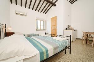 a bedroom with a large bed in a room at Il Podere Del Ponti - Paduletto in Casa Paduletto