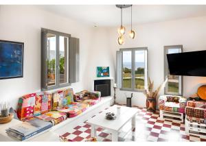 a living room with a couch and a table at Luna Rossa Milos - Olive Home in Provatas