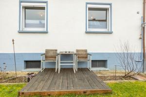 a table and two chairs sitting on a wooden deck at Höhe26 in Bad Vilbel