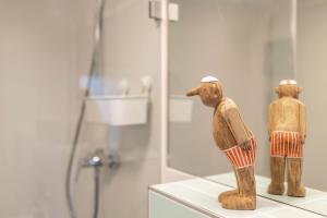 a couple of wooden figurines on a shelf in a bathroom at Höhe26 in Bad Vilbel +17 photos