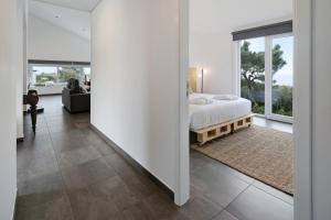 a bedroom with a bed and a large window at Rocha do Mar 2 in Biscoitos +33 photos