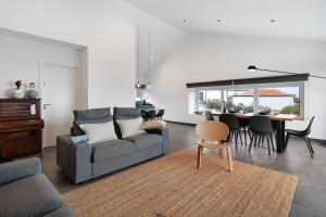 a living room with a couch and a table at Rocha do Mar 2 in Biscoitos