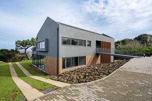 a house on a hill with a stone driveway at Rocha do Mar 2 in Biscoitos