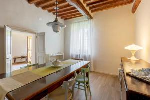 a kitchen with a table and chairs in a room at Corte Croce in Gonzaga
